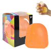 A box of orange squishy stress balls and a hand holding a yellow fidget toy.