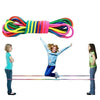 Rainbow elastic jump rope training band stretched across a line with children demonstrating its use.
