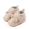 Pair of light beige fuzzy bear design baby prewalker shoes with a soft anti-slip sole