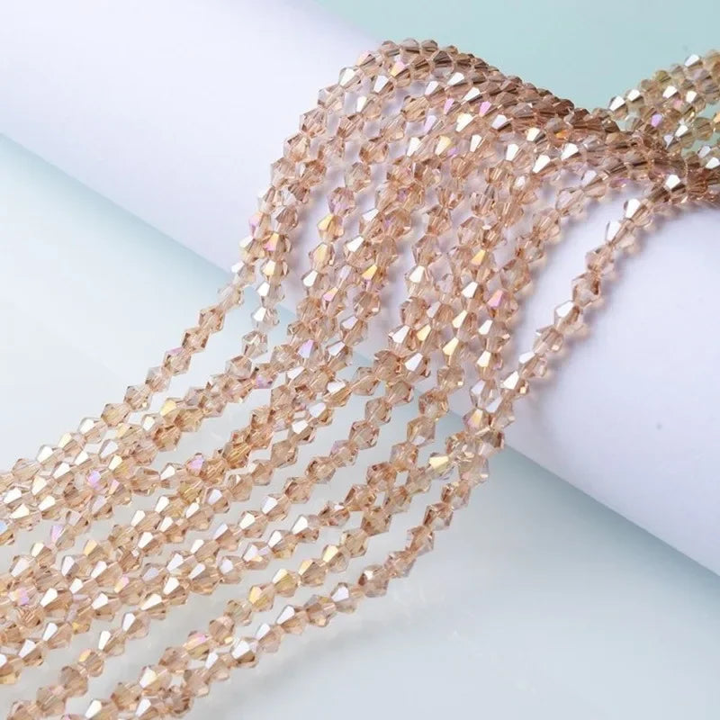 A close-up of strands of multicolor faceted glass crystal beads used for jewelry making.