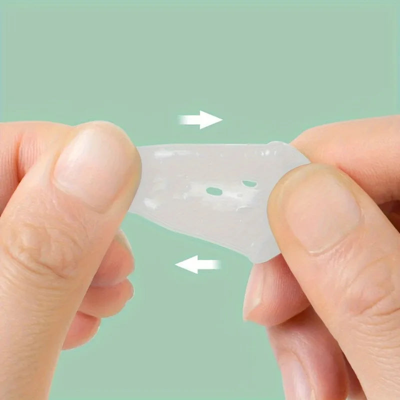 Hands are placing a translucent silicone guitar finger sleeve onto a finger for practice and protection.