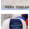 A ball of white merino wool thread labeled Worsted Wool Thread for knitting projects.