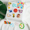 A collection of ten autumn pumpkin flatback resin décor items including a Hello Spring sign and various floral shapes.