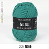 A ball of teal milk cotton yarn labeled with Chinese characters and a size designation.