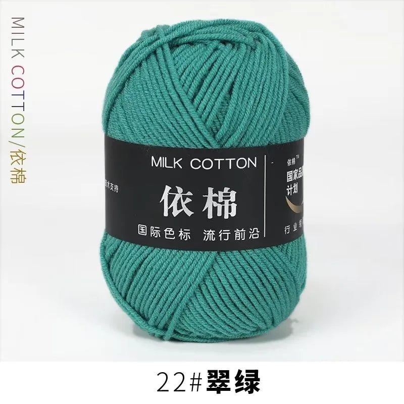 A ball of teal milk cotton yarn labeled with Chinese characters and a size designation.