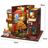 A wooden 3D puzzle dollhouse kit depicting a magical city castle with detailed brick architecture and colorful facades.