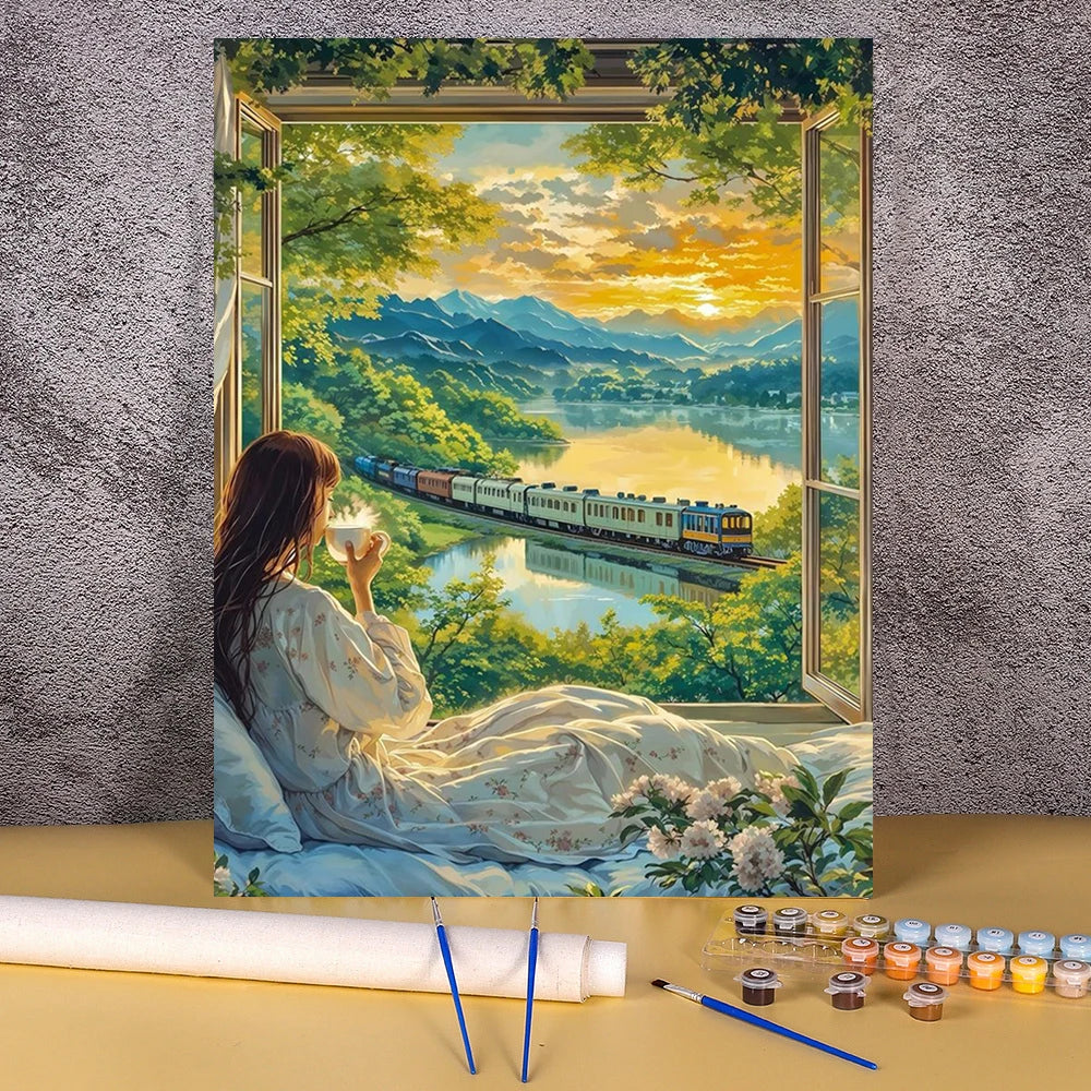 A painting by numbers kit depicting a landscape with a wooden house, flower fields, and a sunset over water.