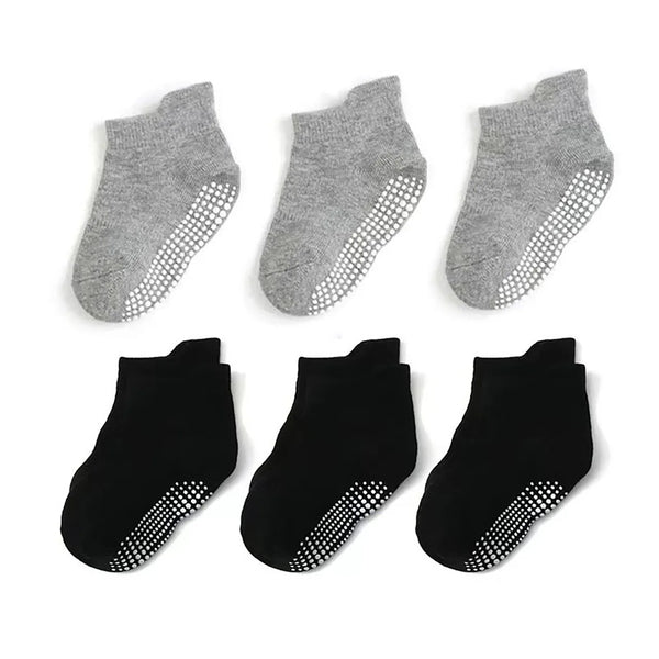 A pack of six cotton anti-slip socks for baby and kids in gray and black colors.