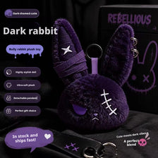 A dark purple rabbit plush toy with a bandage design and keychain attached.