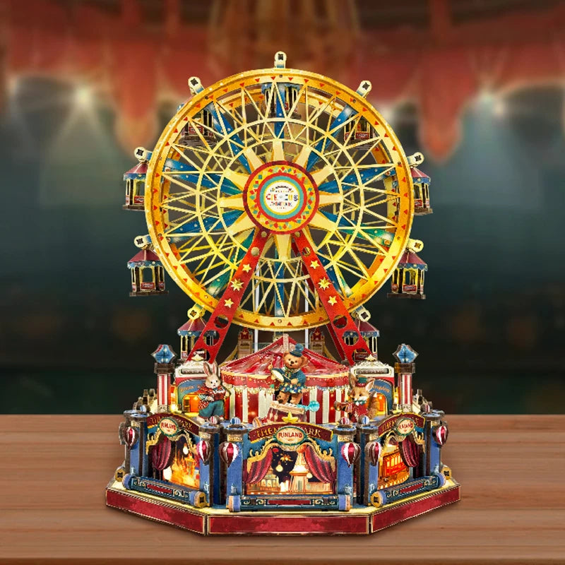 A detailed wooden model kit of a Ferris wheel music box dollhouse featuring an ornate wheel and miniature figures.