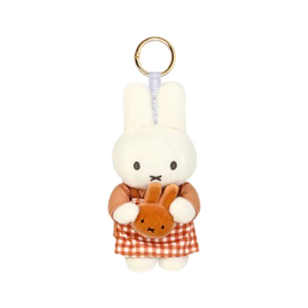 A white Miffy plush keychain charm with a gold ring and an orange checkered fabric.