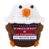 A handmade crochet animal plush doll resembling a white bird with an orange beak and brown body.