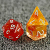 A set of seven polyhedral dice with an orange and red haze swirl effect resting on a dark textured surface.