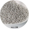 A pile of small, silver-colored electroplated metallic glass beads for jewelry and crafting.