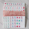 A stack of pearl pink acrylic American Mahjong tiles organized in multiple layers.