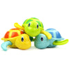 A set of colorful wind-up swimming turtle bath toys in yellow, green, and blue.