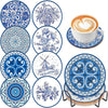 A set of blue and white patterned diamond art coasters with a holder and a cup of coffee.