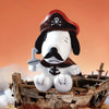 A collectible figure of Snoopy with a black and white face, wearing a red hat and a dark collar, sitting on a wooden crate.