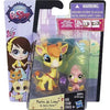 A set of three small plastic animal figures, including a lion cub and other animals, packaged in a purple box.