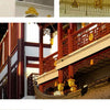 A close-up of a traditional Chinese architectural facade featuring red and gold woodwork and pillars.