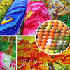 Close-up of diamond painting art featuring vibrant colors and textures on fabric.