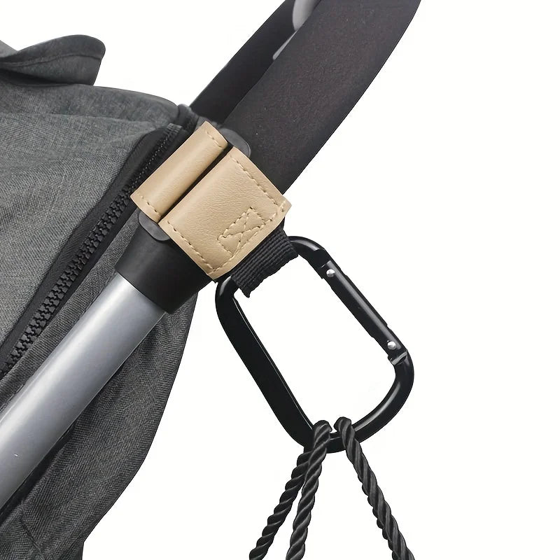Close-up of a gray fabric bag with a beige strap and black hook mechanism for hands-free organization.