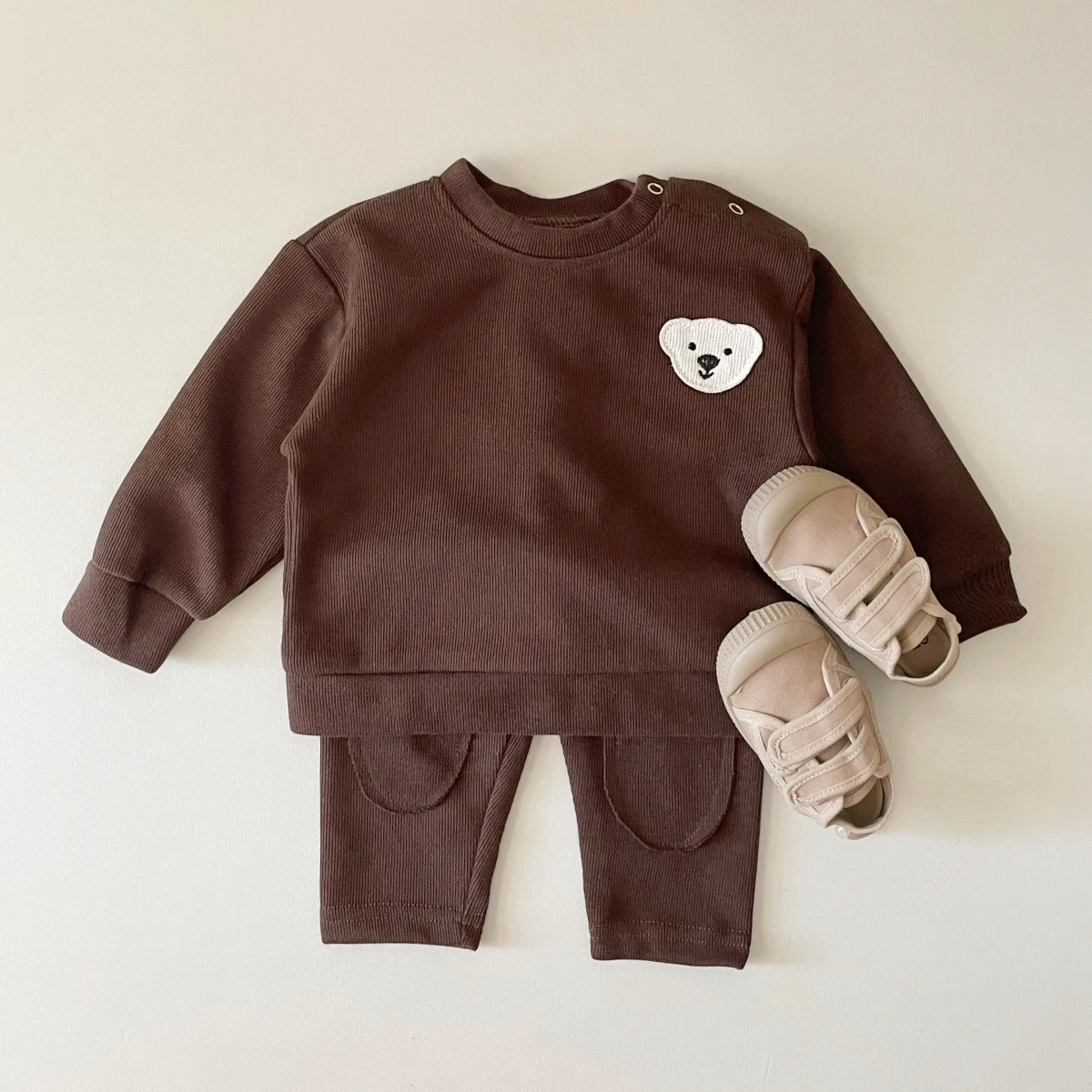 A brown baby long sleeve cartoon top and pants set featuring a white bear design.