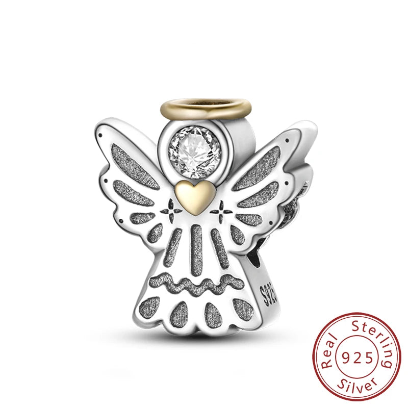 A sterling silver charm featuring an angel design with a heart and a clear stone, set against a white background.