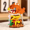 An orange shark building block figure with yellow teeth and a white body stands atop a yellow base.
