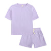 A lilac kids summer tracksuit set featuring a short sleeve top and matching shorts.