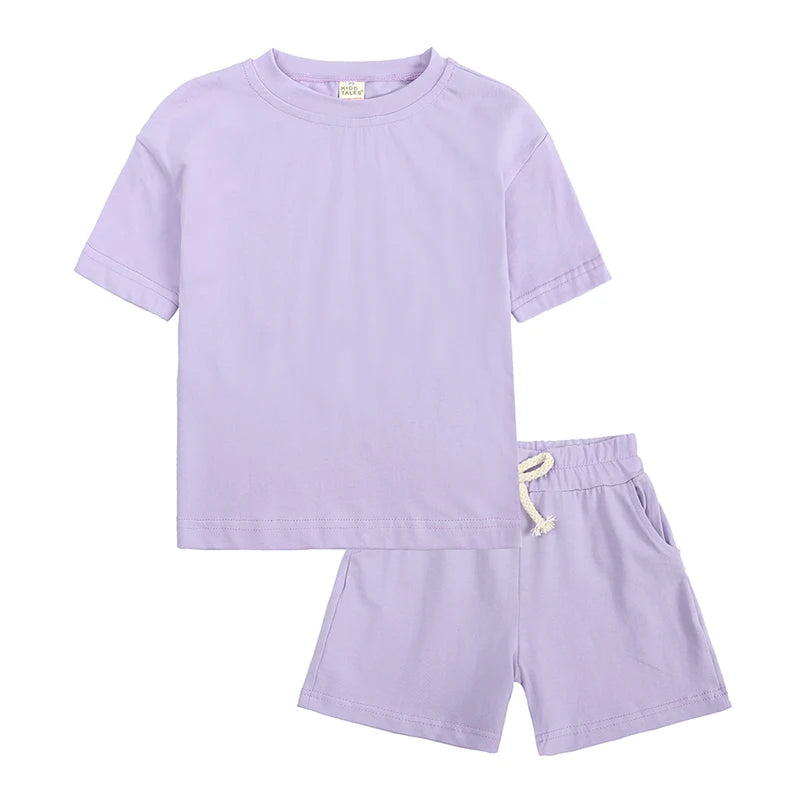 A lilac kids summer tracksuit set featuring a short sleeve top and matching shorts.