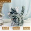 A gray tabby plush cat toy with a wagging tail and simulated sound, shown in a close-up view.