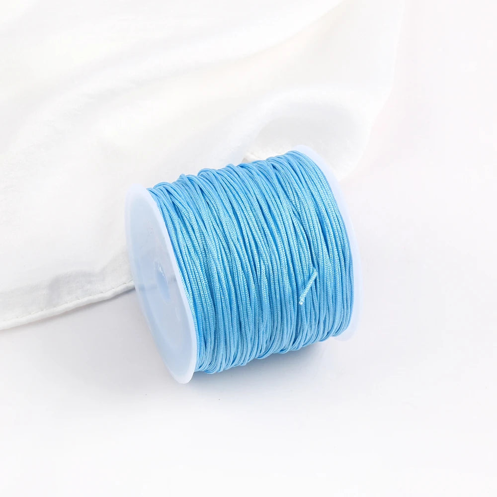 A roll of light blue 0.8mm cotton nylon macrame cord for jewelry making and crafts.