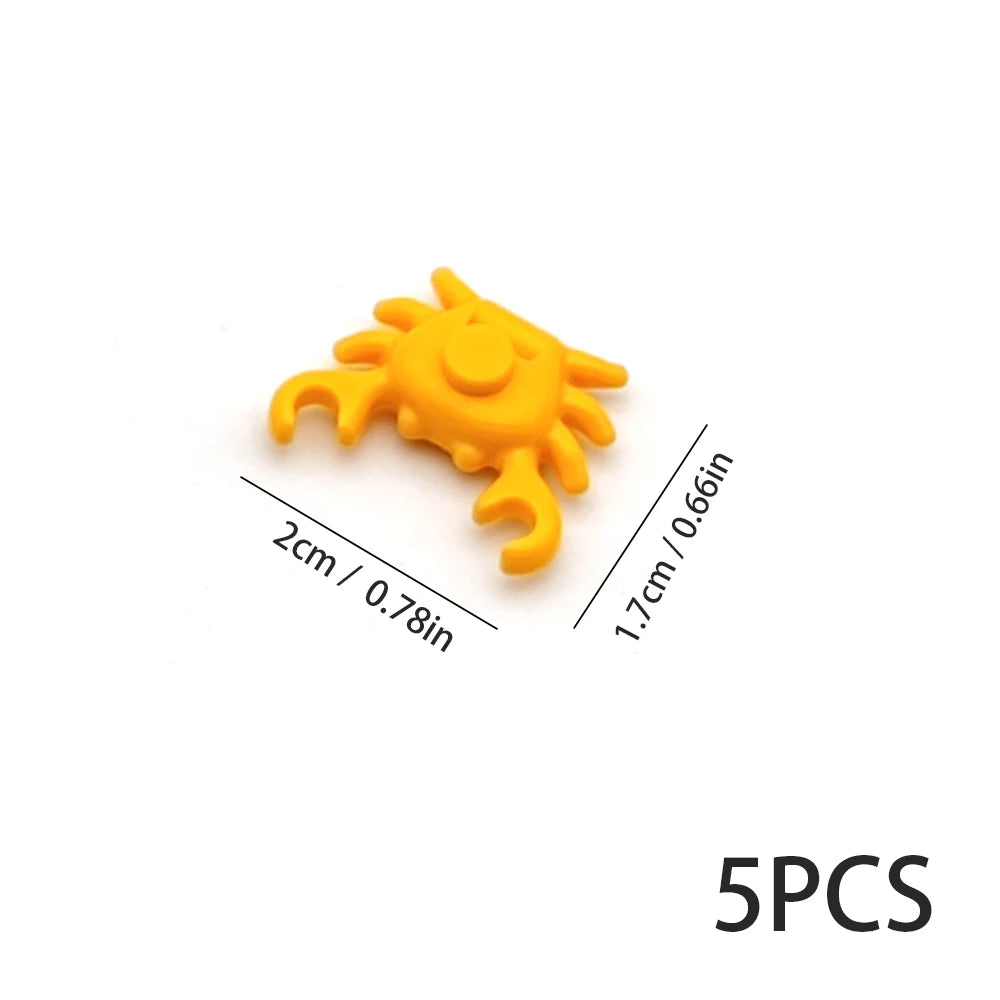 Five yellow plastic ocean animal building blocks or marine creatures.