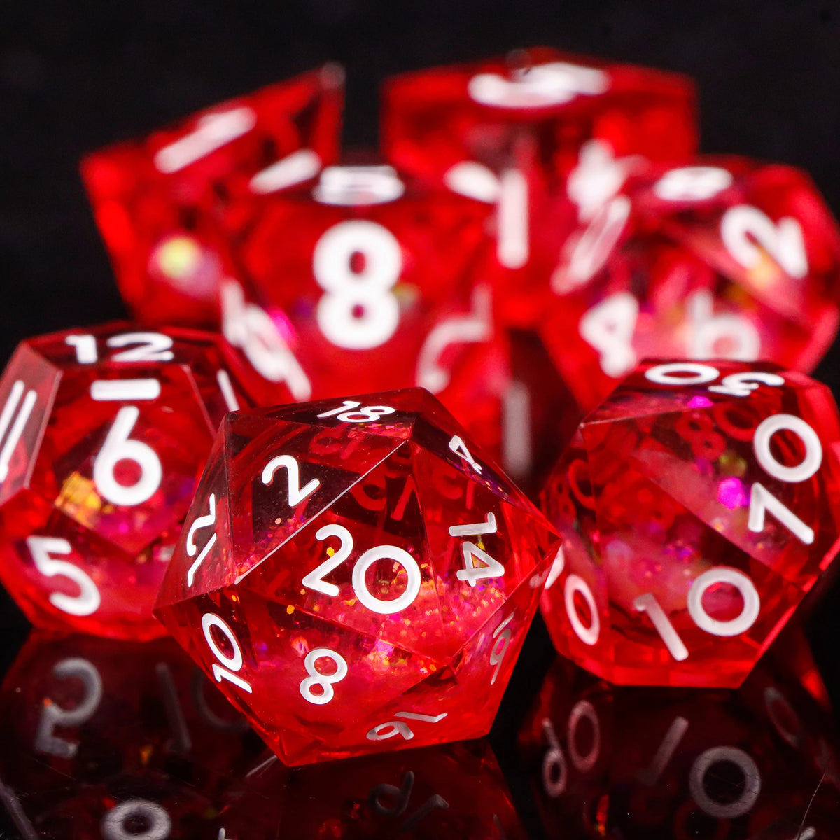 A close-up of a set of glossy red resin dice scattered on a dark surface.