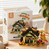 A cardboard box for a Forest Cabin micro building blocks set featuring a house, greenhouse, and windmill.