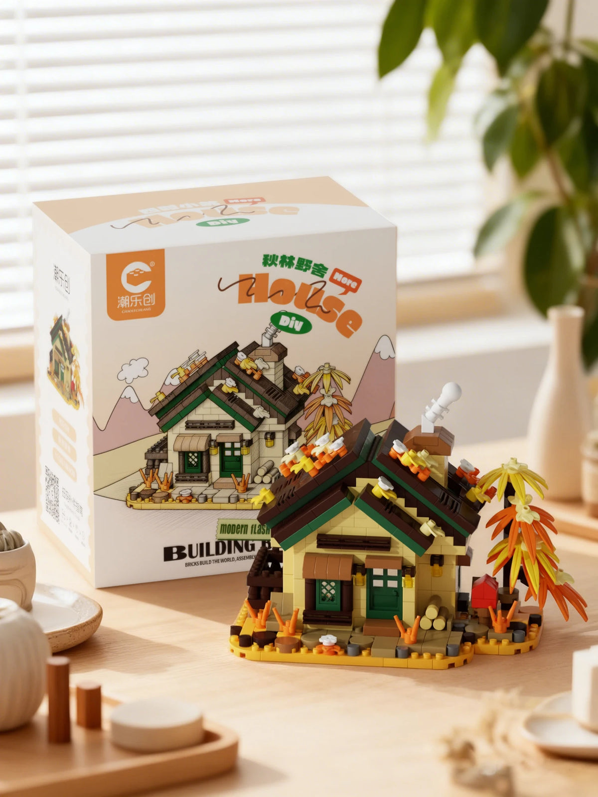 A cardboard box for a Forest Cabin micro building blocks set featuring a house, greenhouse, and windmill.