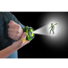 A hand holds a green projector device emitting a bright beam onto a figure resembling a Ben 10 alien.