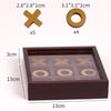 A wooden tic tac toe strategy game box containing five X shapes and four O shapes.