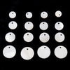 A row of twelve natural white shell beads in various round sizes arranged on a black surface.