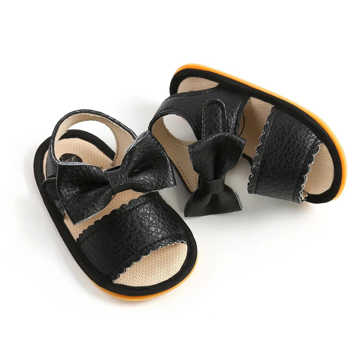 Black baby summer sandals with a bowknot and an orange sole