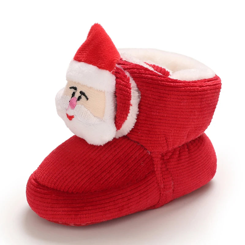 A red baby winter boot with a white trim and a festive Santa face design.
