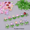 A collection of pink and green glass petals and leaves for crafting, showing various sizes.
