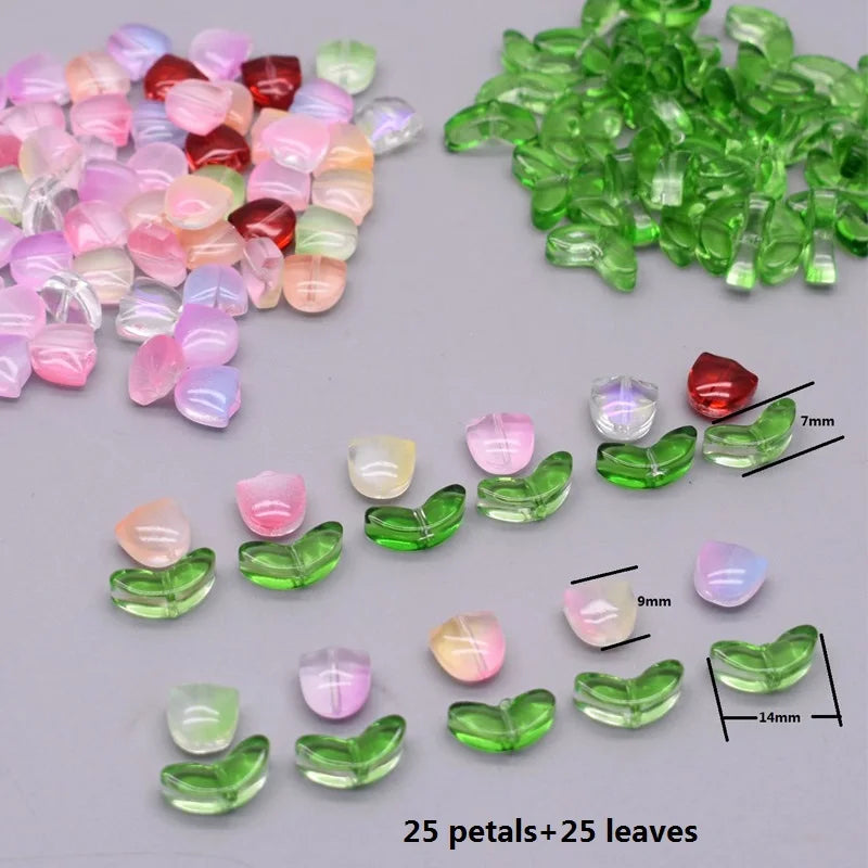 A collection of pink and green glass petals and leaves for crafting, showing various sizes.
