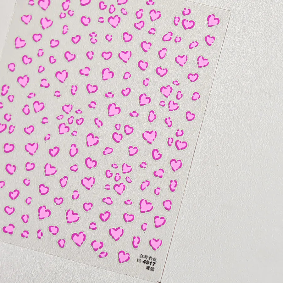 Pink heart shaped nail art stickers with a leopard print pattern on a white background
