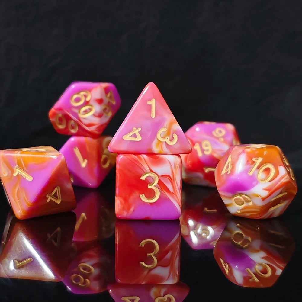 A collection of seven polyhedral dice featuring a vibrant pink and orange swirl pattern on a dark background.