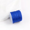 A roll of bright blue 0.8mm cotton nylon macrame cord for jewelry making and crafts.