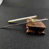 A samurai sword keychain featuring a white blade and hilt resting on a dark surface.