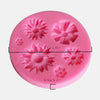 A pink silicone mold with seven flower shapes for decorating fondant, cake, and chocolate.