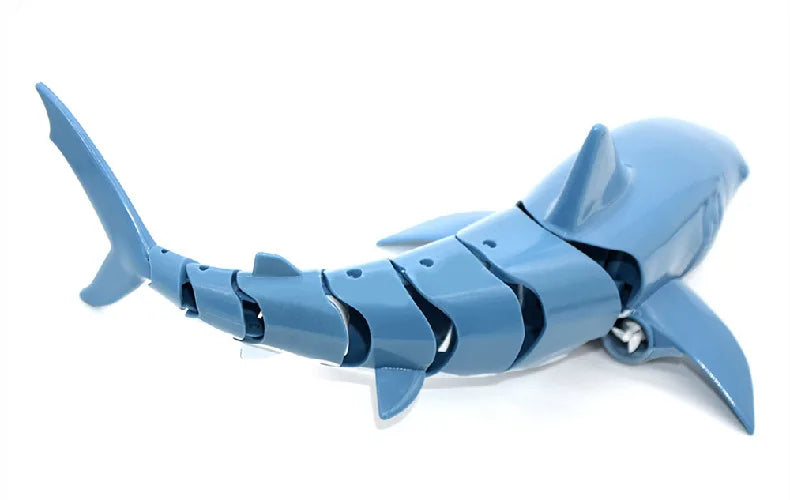 A blue remote control shark toy with light and water spray.